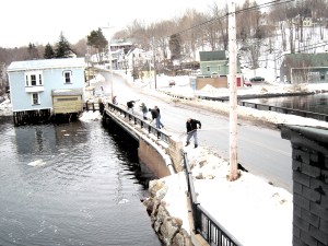 Community volunteers clearing snow and ice for Winter Carnival.